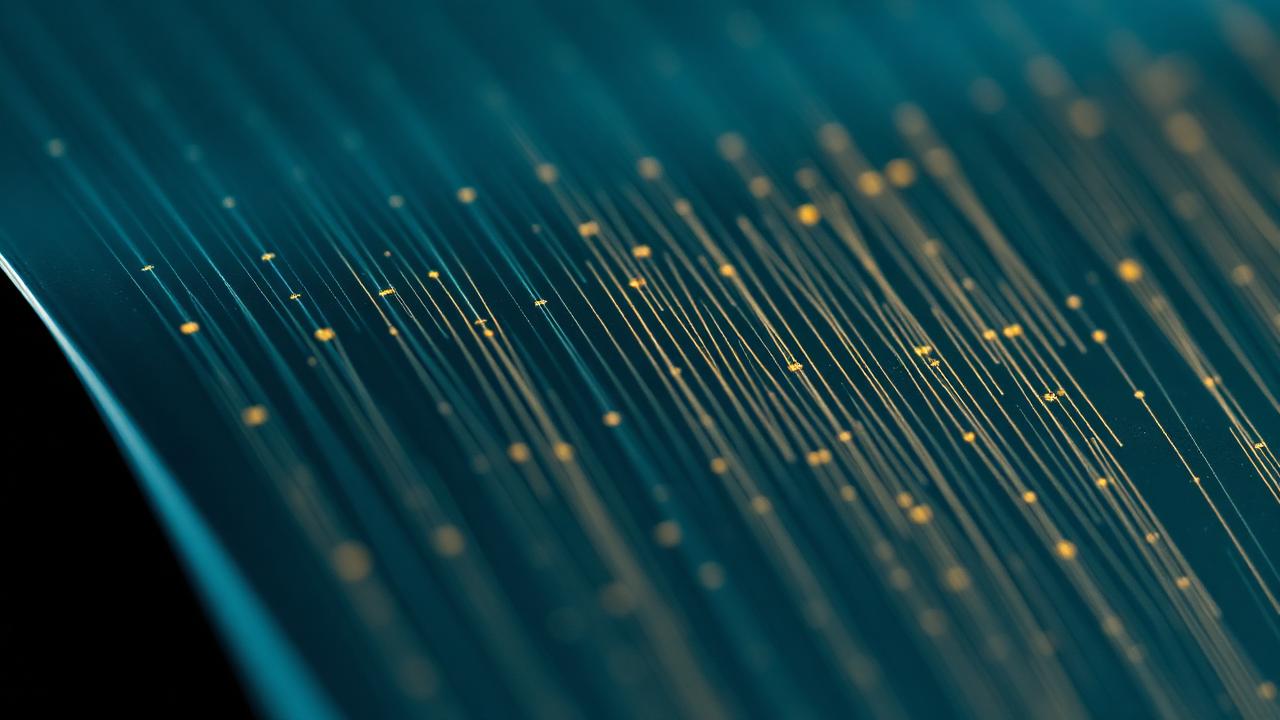 Microscopic view of a flexible electrode array with fine conductive traces beside neural tissue